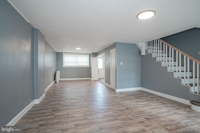 basement featuring radiator and wood-type flooring