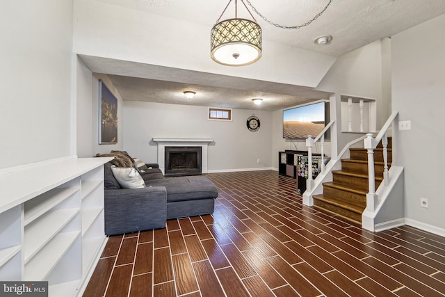 living room with a textured ceiling and lofted ceiling