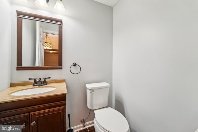 bathroom featuring toilet and vanity