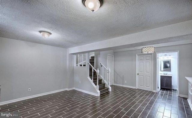 basement featuring a textured ceiling