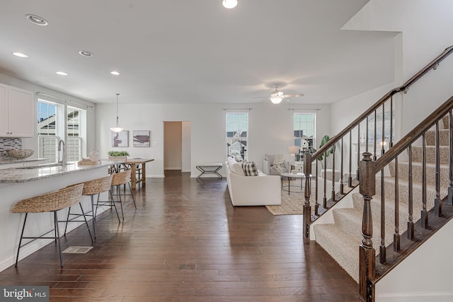 interior space featuring baseboards, stairway, recessed lighting, dark wood-style floors, and a ceiling fan