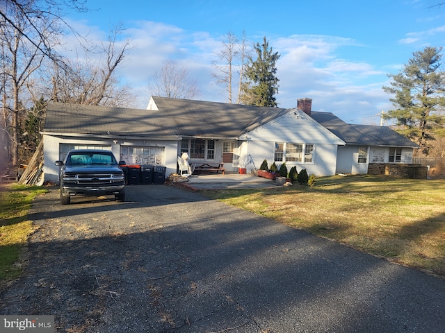 ranch-style home with a front lawn