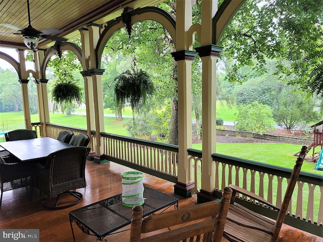 deck featuring a lawn, ceiling fan, and a porch