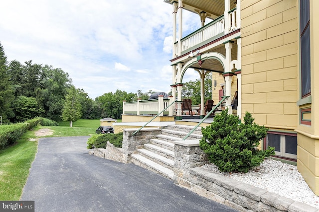 view of home's exterior featuring covered porch and a balcony