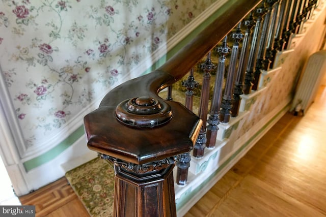 interior details featuring radiator heating unit and hardwood / wood-style flooring