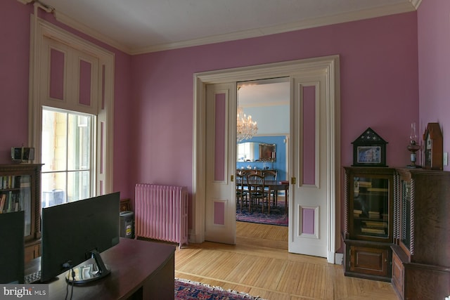 office area with radiator, an inviting chandelier, and ornamental molding