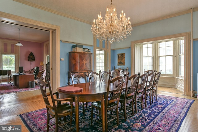 dining space with a chandelier, a wealth of natural light, and crown molding