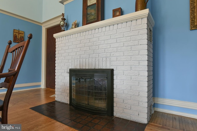 room details with wood-type flooring and a brick fireplace