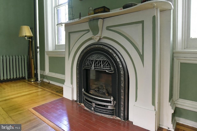 details featuring radiator and hardwood / wood-style floors