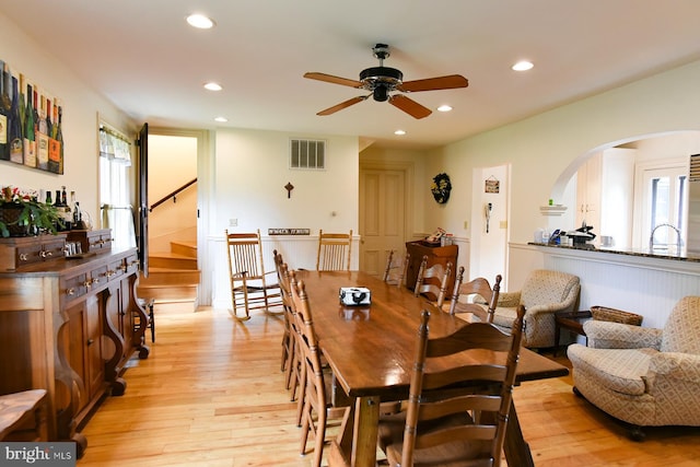 dining area with ceiling fan and light hardwood / wood-style floors