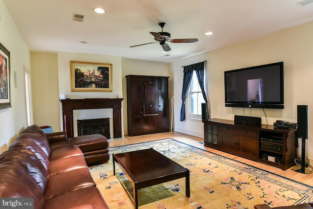 living room featuring ceiling fan and light hardwood / wood-style floors