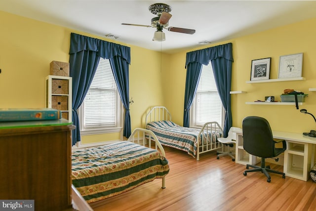 bedroom with ceiling fan and light hardwood / wood-style flooring