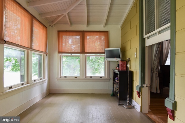 interior space featuring lofted ceiling with beams