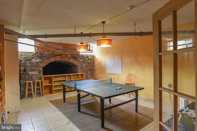 recreation room with beamed ceiling and tile patterned flooring