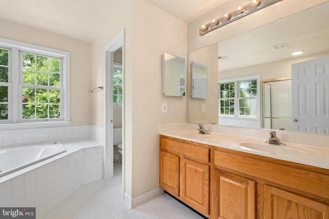 bathroom featuring a bath, tile patterned flooring, a sink, and toilet