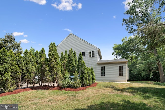 back of property featuring a lawn