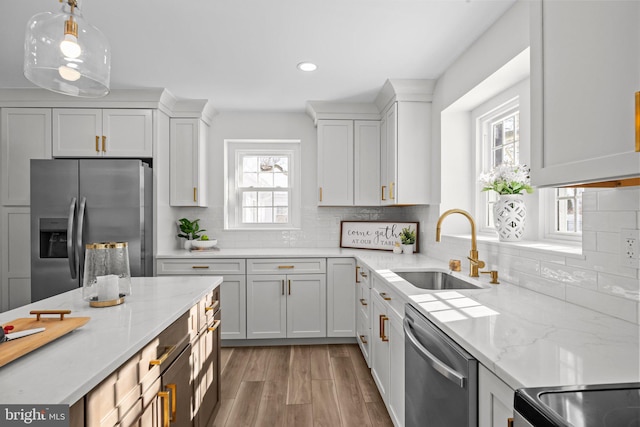 kitchen featuring appliances with stainless steel finishes, sink, and white cabinets