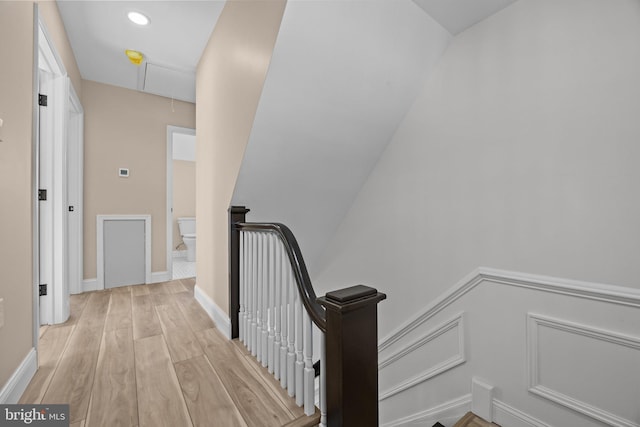 staircase with hardwood / wood-style flooring