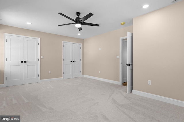 unfurnished bedroom with ceiling fan and light carpet