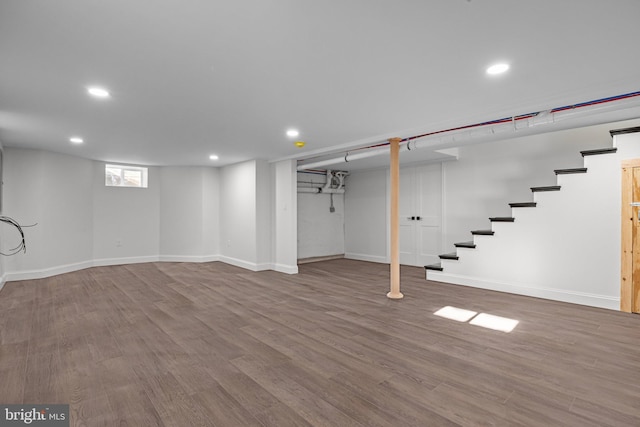 basement with hardwood / wood-style floors