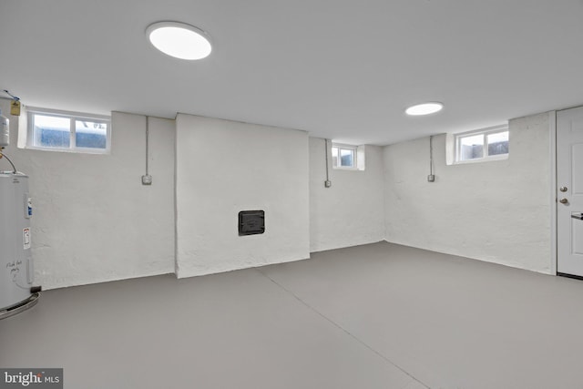 basement with a wealth of natural light and water heater