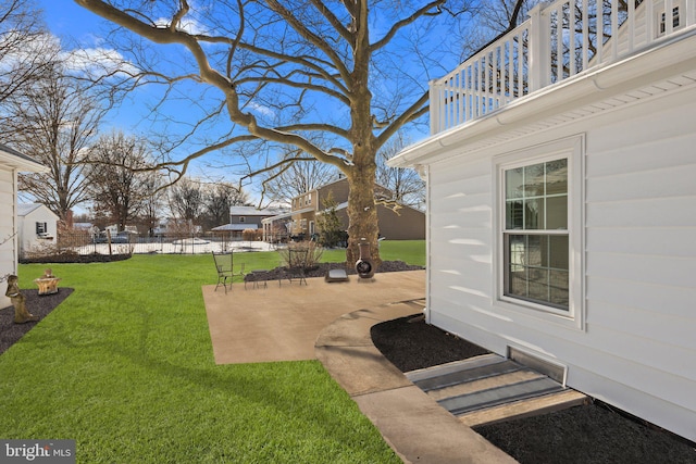 view of yard with a patio area and a balcony