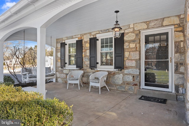 doorway to property featuring covered porch