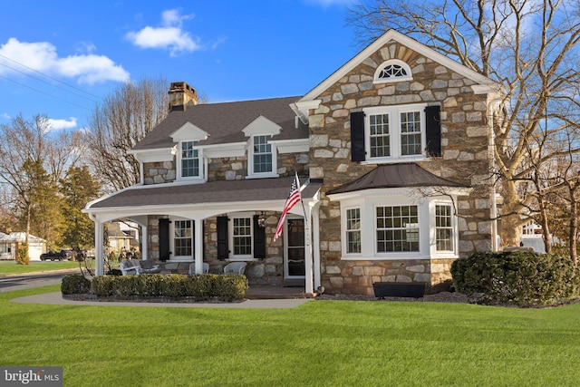 view of front property with a front yard and covered porch