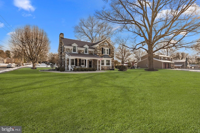 rear view of house featuring a lawn