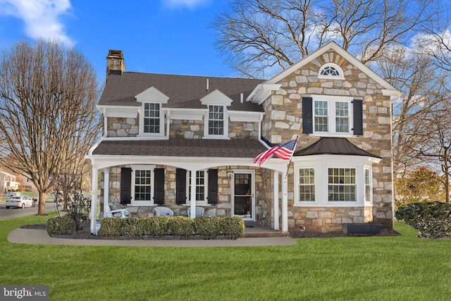 view of front property featuring a front yard and covered porch