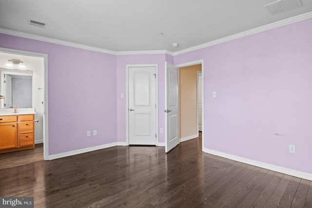 unfurnished bedroom featuring dark wood-style floors, visible vents, ornamental molding, and baseboards