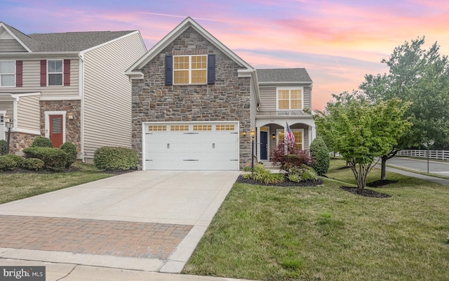 view of front of home featuring a garage and a yard