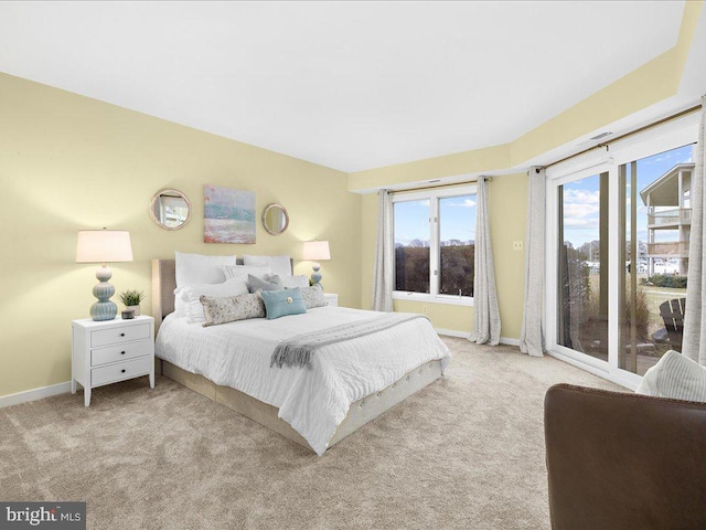 carpeted bedroom featuring access to outside