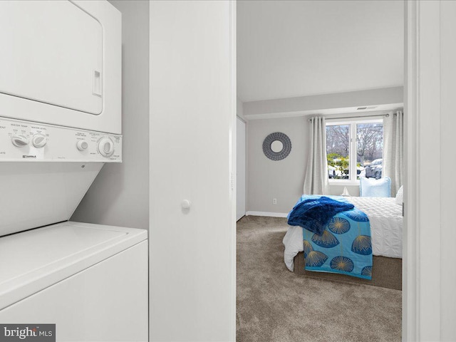 laundry room with stacked washing maching and dryer and light colored carpet