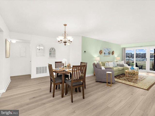 dining space featuring a notable chandelier and light hardwood / wood-style flooring