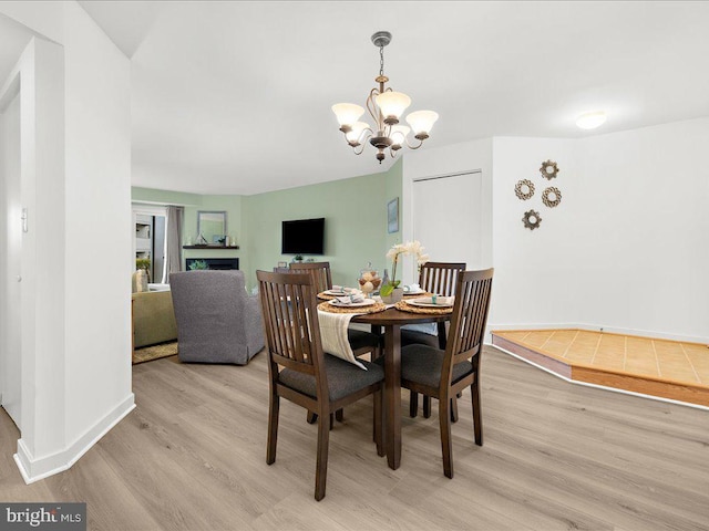 dining room with a notable chandelier and light hardwood / wood-style flooring