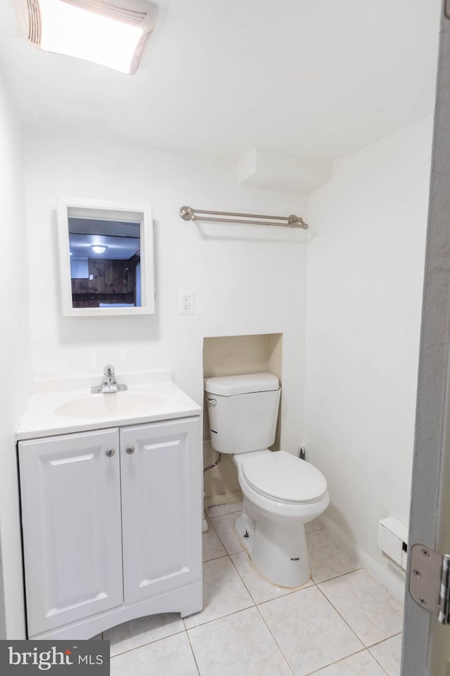 bathroom featuring tile patterned flooring, vanity, and toilet