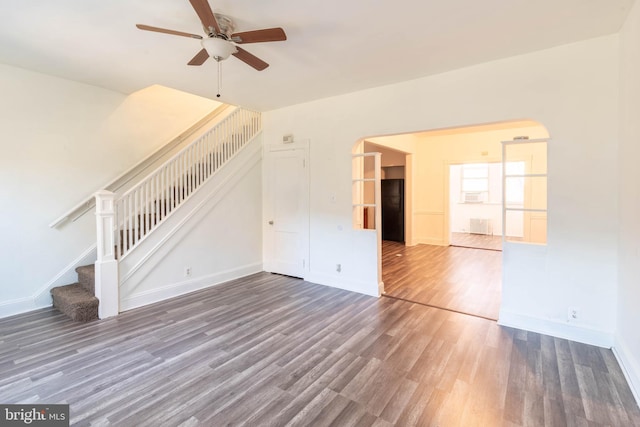 unfurnished living room featuring dark hardwood / wood-style flooring and ceiling fan