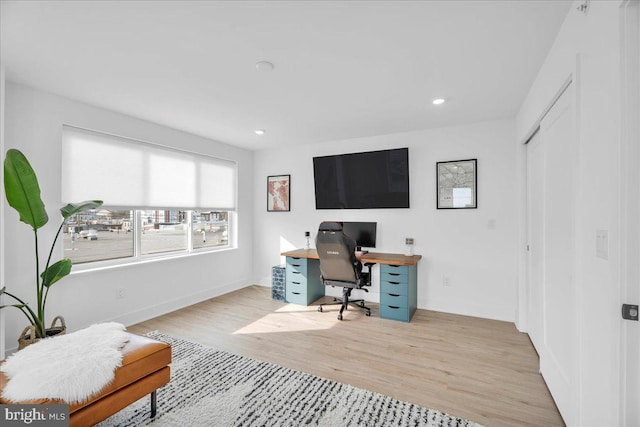 office with light wood-type flooring