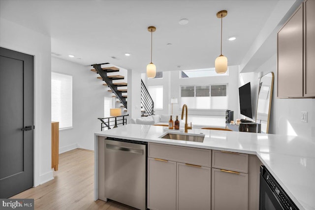 kitchen featuring stainless steel dishwasher, pendant lighting, gray cabinetry, and sink