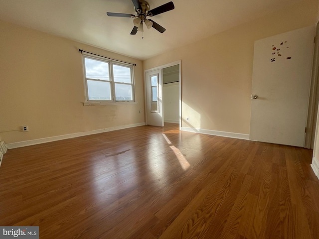 spare room with hardwood / wood-style floors and ceiling fan