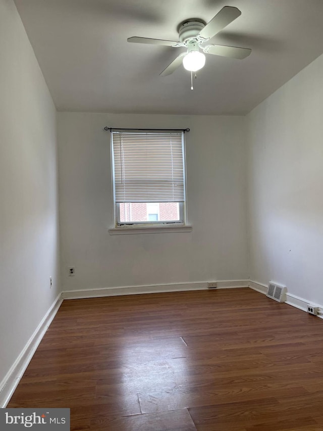 spare room featuring ceiling fan and dark hardwood / wood-style floors