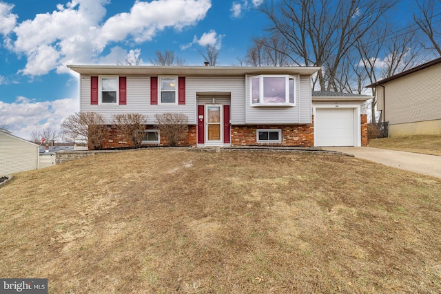 bi-level home featuring a garage and a front lawn