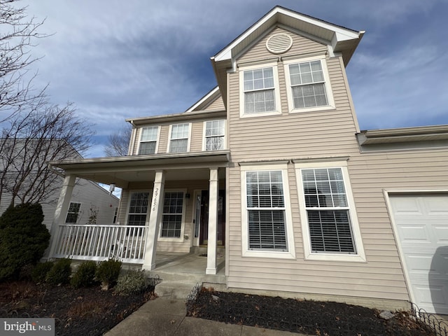 view of front of house featuring a porch and a garage