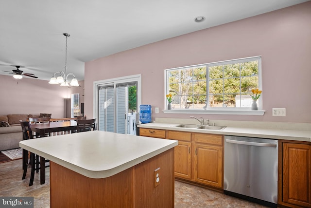 kitchen with sink, hanging light fixtures, stainless steel dishwasher, and ceiling fan with notable chandelier