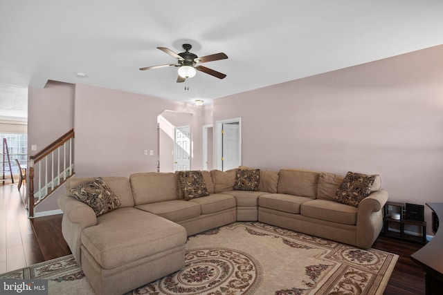 living room with ceiling fan and dark hardwood / wood-style floors