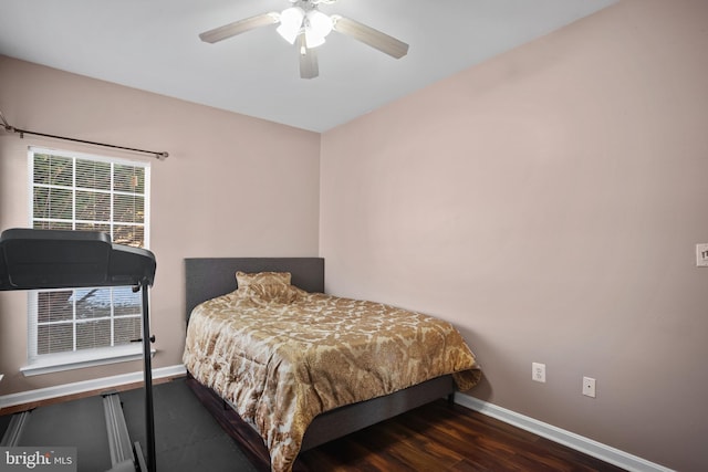 bedroom with ceiling fan and dark wood-type flooring