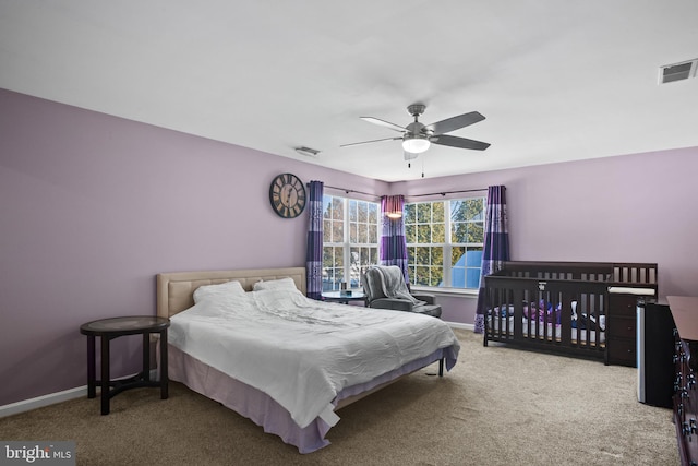 bedroom featuring light carpet and ceiling fan