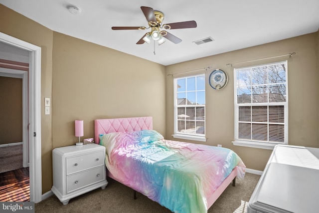 bedroom featuring dark carpet and ceiling fan