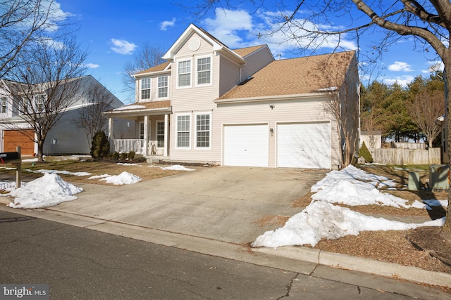 view of property with a porch and a garage